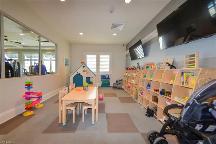 Recreation room with recessed lighting and baseboards