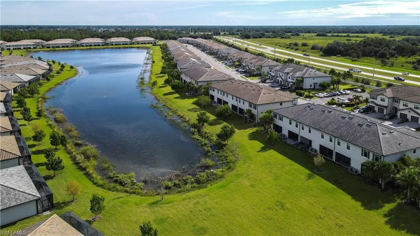 Aerial perspective of suburban area featuring a nearby body of water