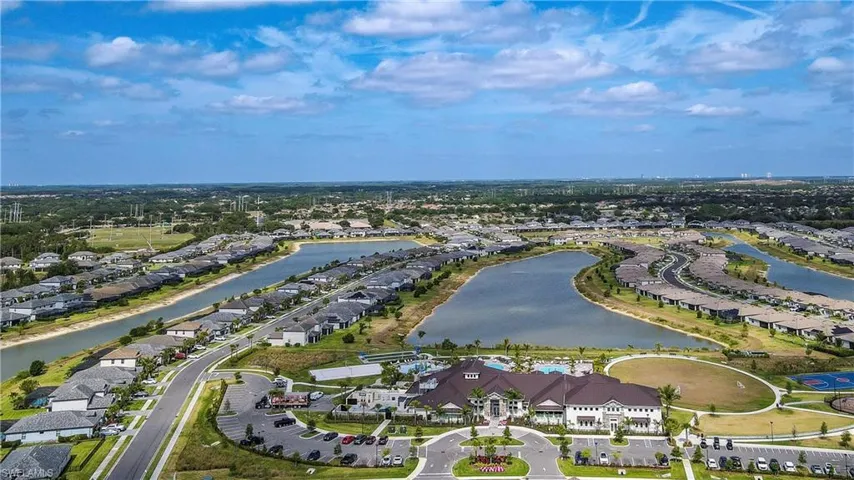 Aerial perspective of suburban area featuring a large body of water