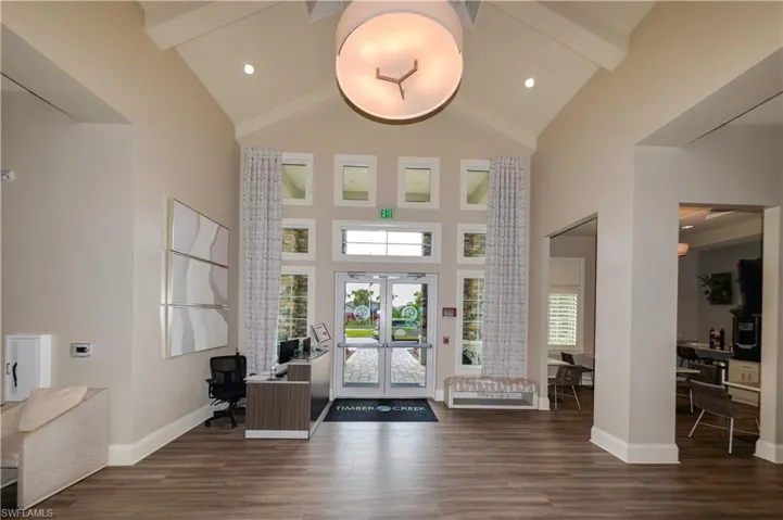 Foyer entrance featuring french doors, dark wood finished floors, high vaulted ceiling, and recessed lighting