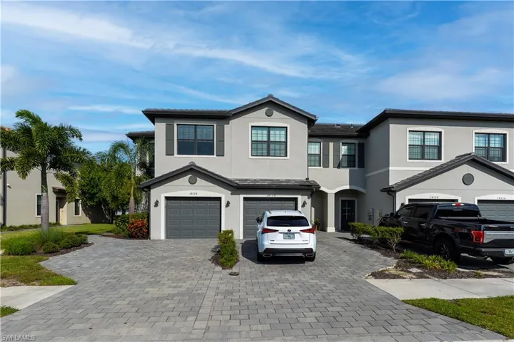 View of front of property featuring decorative driveway, stucco siding, and a garage