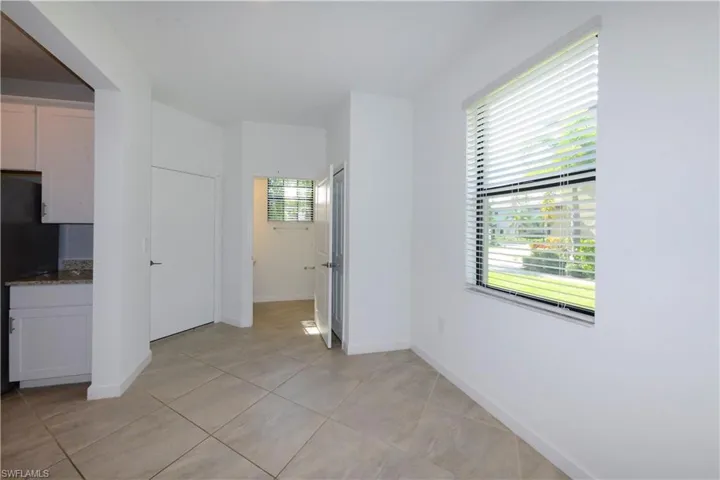 Unfurnished room with baseboards and light tile patterned floors