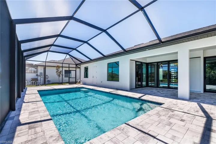 Outdoor pool with a patio area and a lanai