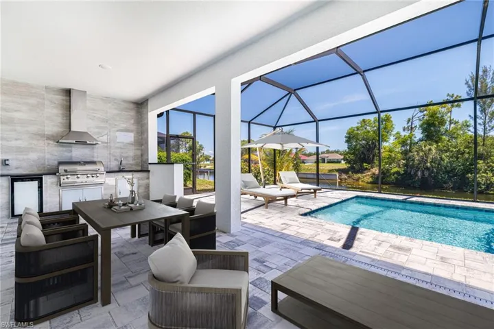 View of patio with glass enclosure, an outdoor pool, outdoor dining space, and an outdoor living space
