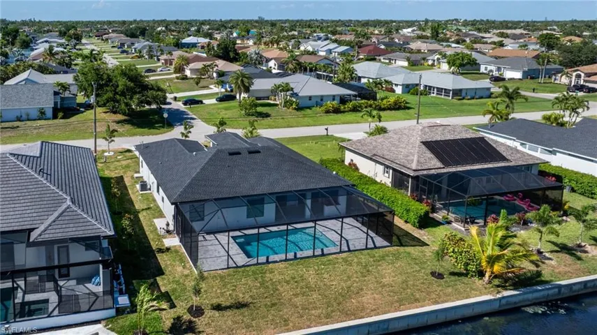 Aerial view of residential area featuring a pool area