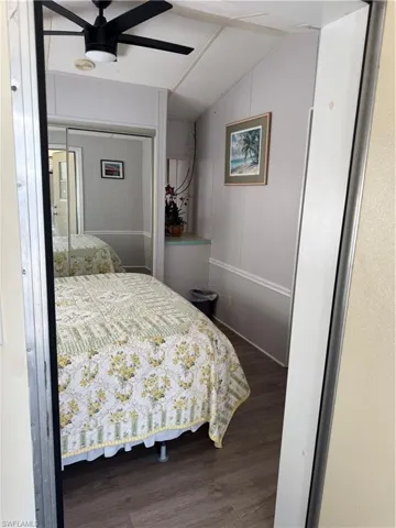 doors, wood-finish flooring, and white paneled walls