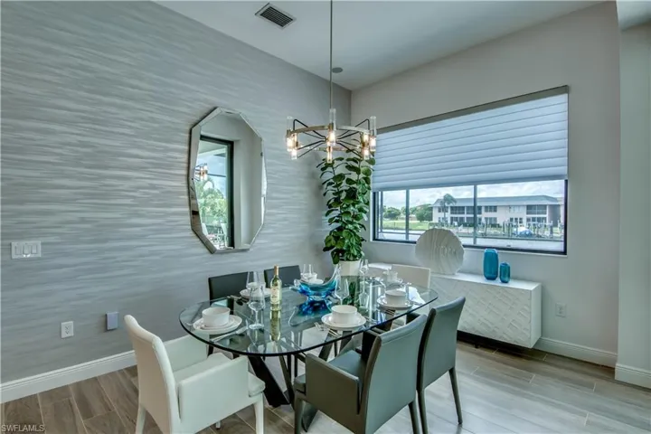 Dining area with wood tiled floors and a chandelier