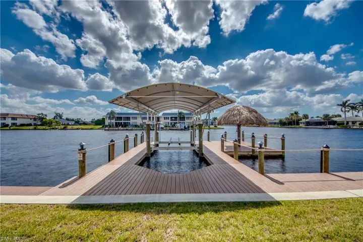 Dock featuring a water view and a yard