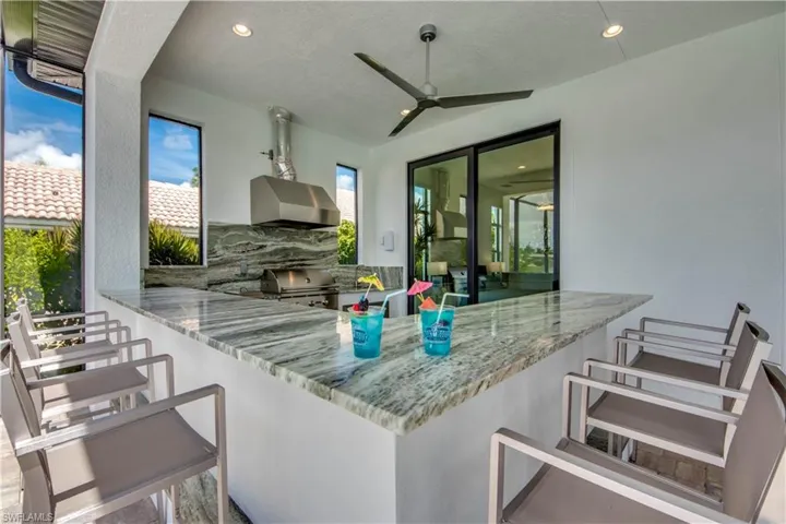 View of patio featuring exterior kitchen and a ceiling fan