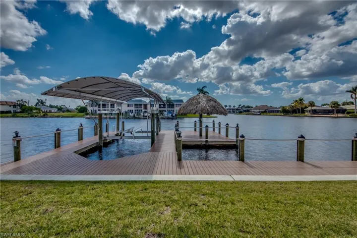 Dock with a water view, a yard, and boat lift