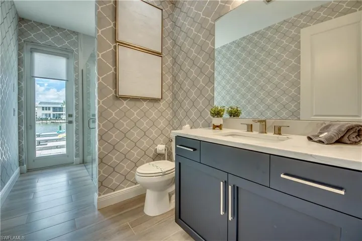 Bathroom featuring vanity, wood tiled floors, and tile walls