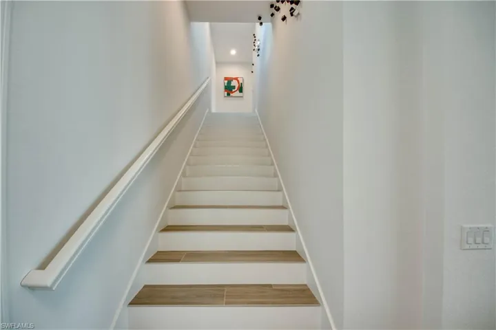 Workout area featuring healthy amount of natural light and light wood finished floors
