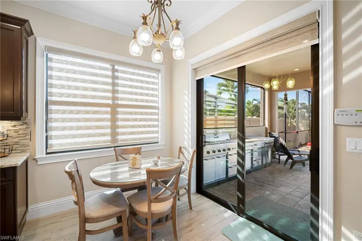 Dining area featuring a chandelier, light wood-style floors, and crown molding