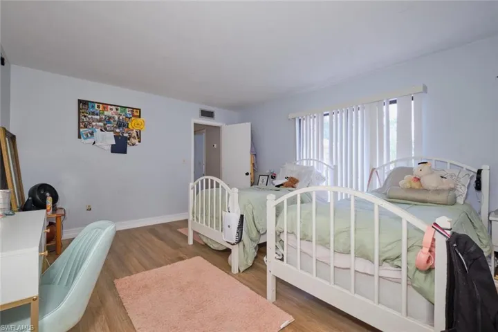 Bedroom with wood-type flooring