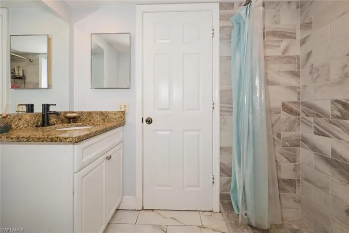 Bathroom with tile patterned flooring and vanity