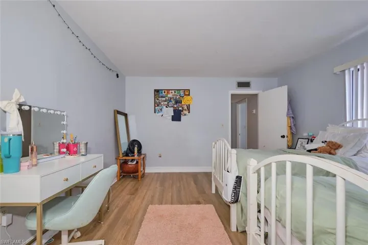 Bedroom with light hardwood / wood-style floors