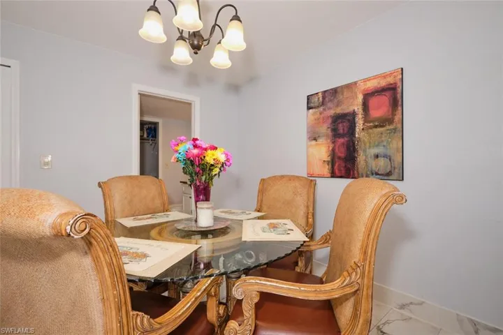 Tiled dining room with an inviting chandelier