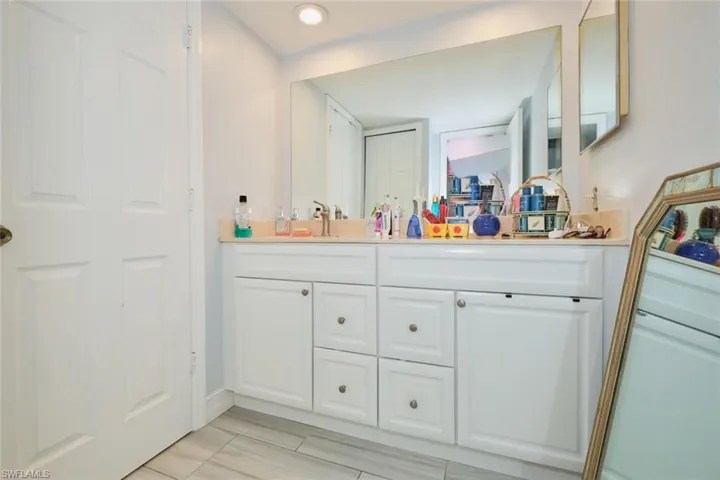 Bathroom with tile patterned floors and vanity