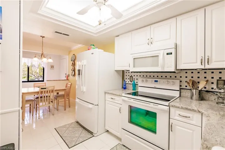 Kitchen with updated ceiling feature and roomy dining area