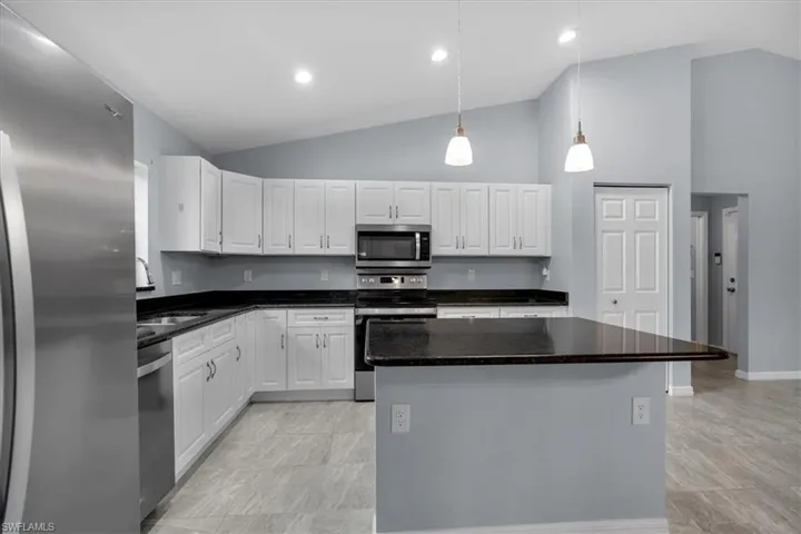Island kitchen with pantry and granite countertops
