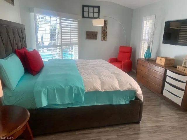 Bedroom featuring hardwood / wood-style flooring and multiple windows