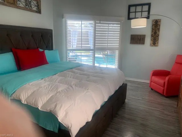 Bedroom with dark hardwood / wood-style floors