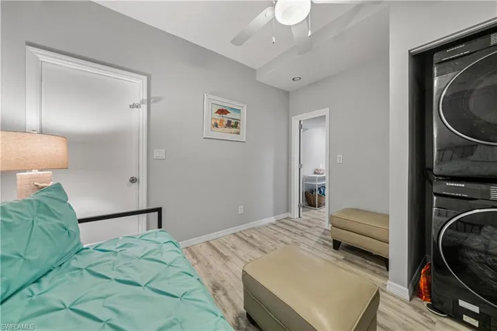 Bedroom 4 or other with LVP floors, stacked washer and dryer, and ceiling fan. Access to Garage.