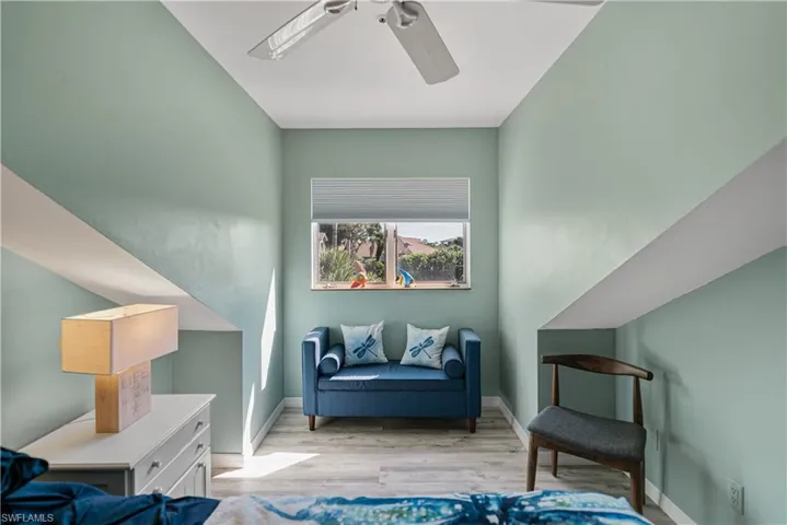 Bedroom 2 Sitting area with ceiling fan and LVP