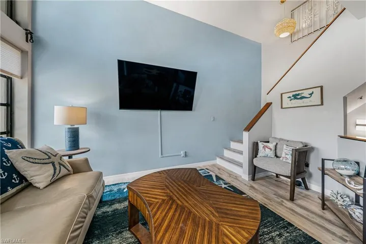 Living room featuring a high ceiling and LVP flooring.