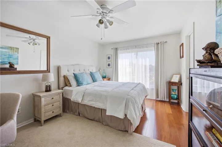Bedroom with ceiling fan and light wood-type flooring