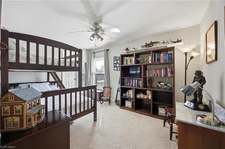 Bedroom featuring light colored carpet and ceiling fan