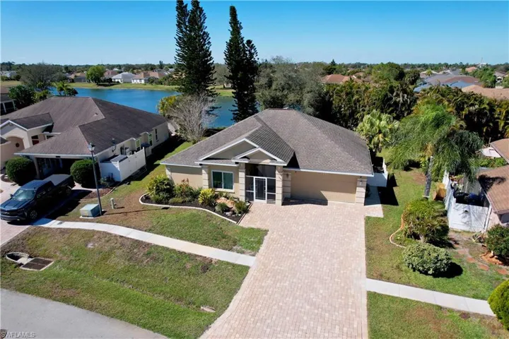 Aerial perspective of suburban area featuring a nearby body of water