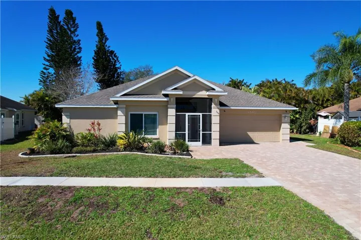 Single story home with a garage, stucco siding, decorative driveway, a front yard, and roof with shingles