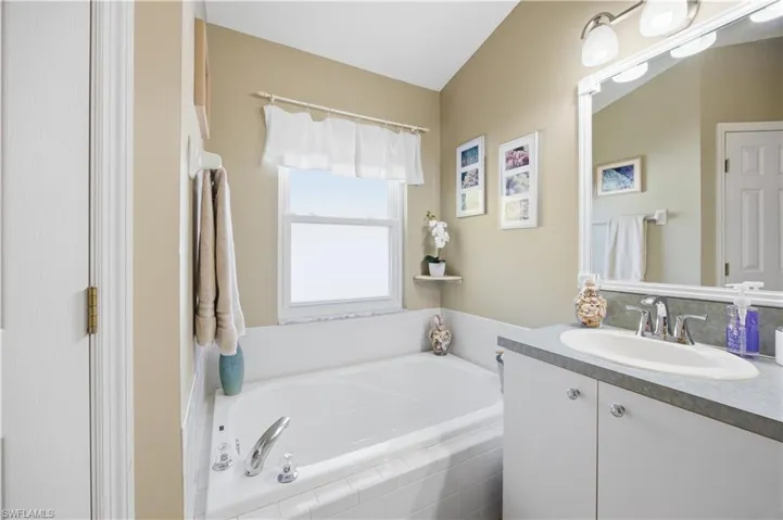 Bathroom featuring vanity and a bath