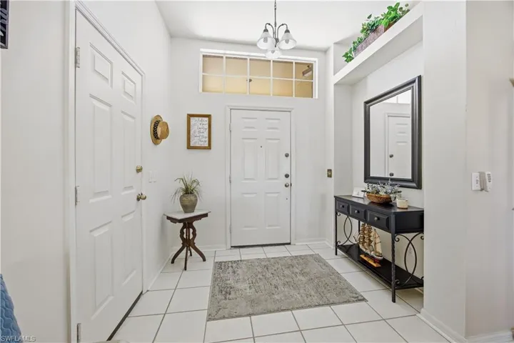 Entryway with light tile patterned floors