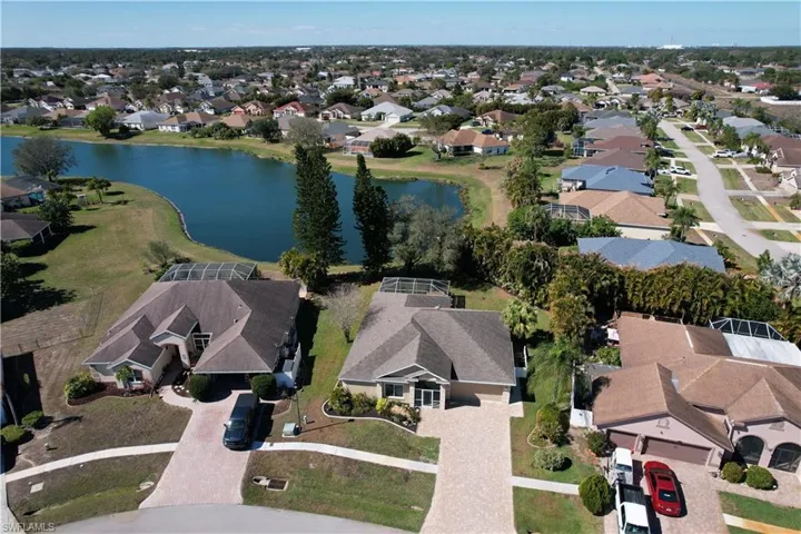 Aerial view of residential area featuring a nearby body of water