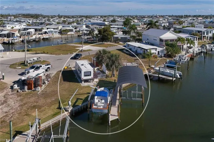 Aerial view of residential area featuring a nearby body of water