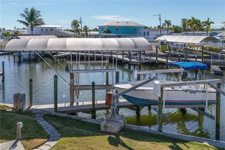Dock with boat lift and a water view