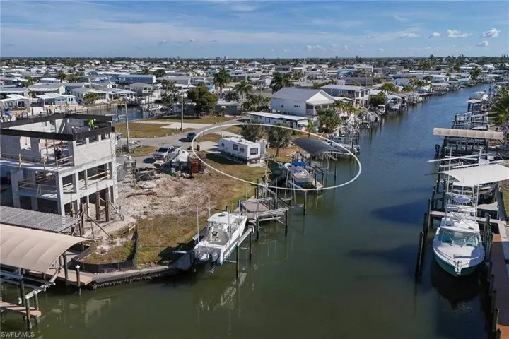 Aerial perspective of suburban area featuring a nearby body of water