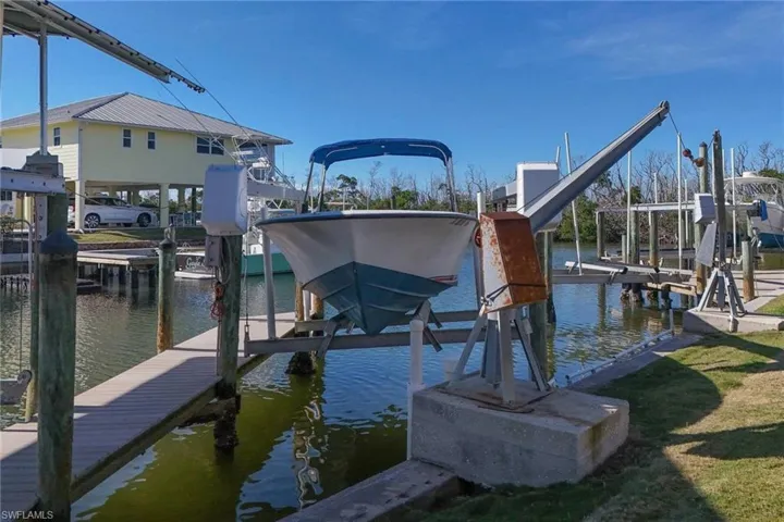 Dock area with a water view and boat lift