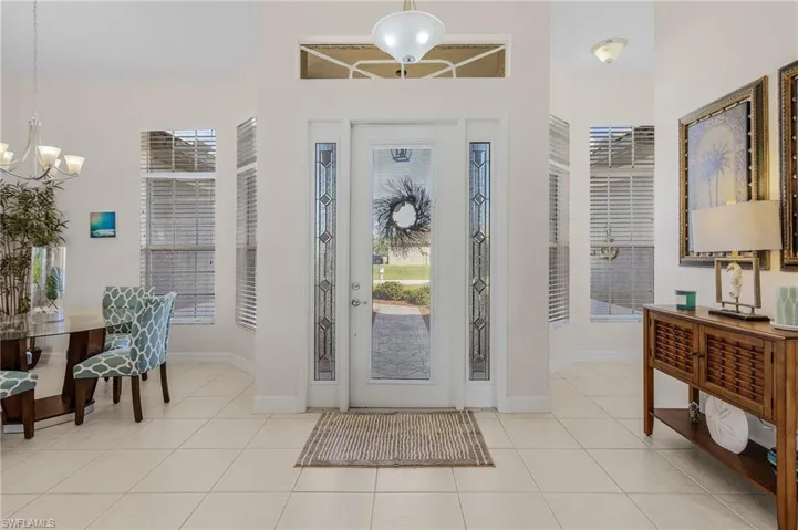 Tiled entrance foyer featuring an inviting chandelier