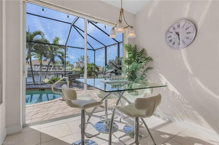 Sunroom featuring a swimming pool and a water view