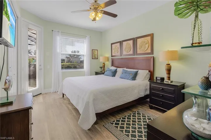 Bedroom with access to exterior, ceiling fan, and light hardwood / wood-style flooring