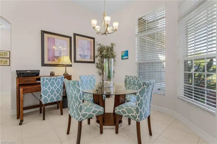 Tiled dining space with a notable chandelier