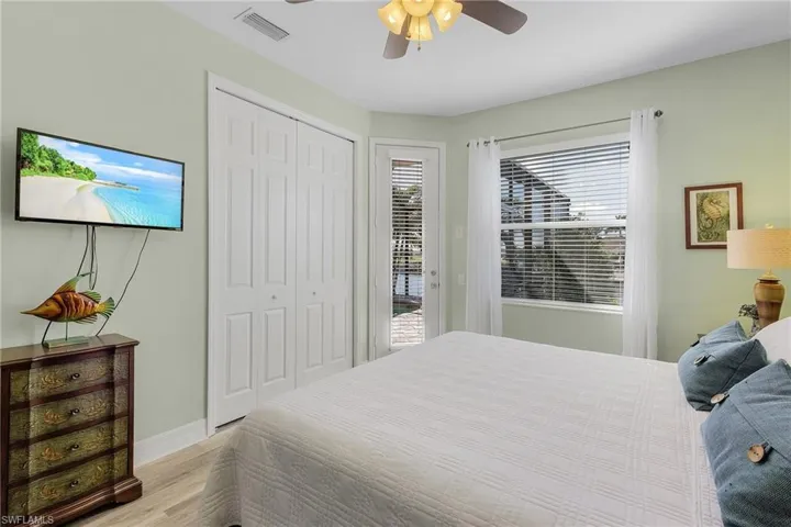 Bedroom with access to outside, a closet, light hardwood / wood-style floors, and ceiling fan