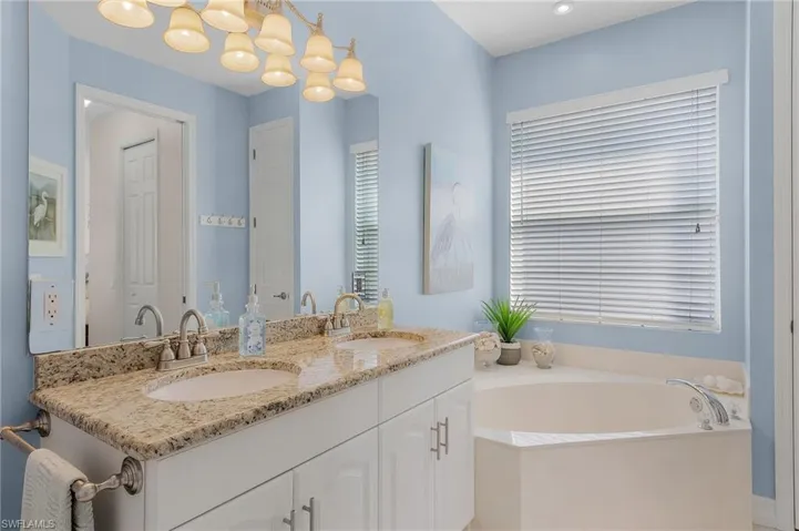 Bathroom featuring vanity and a tub to relax in