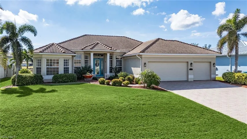 Mediterranean / spanish-style home featuring a front yard and a garage