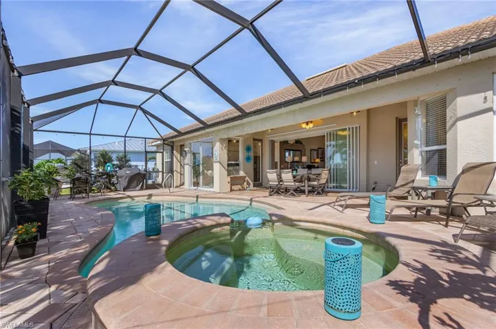 View of pool featuring an in ground hot tub, a patio, and a lanai