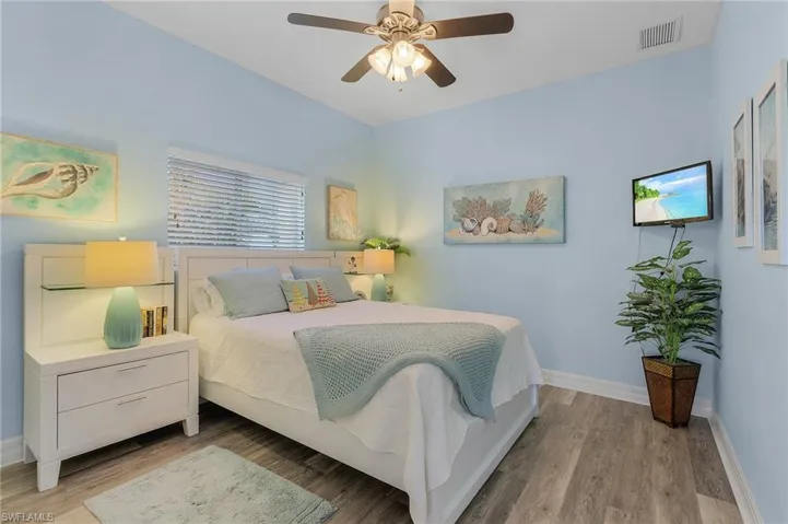 Bedroom with ceiling fan and light wood-type flooring