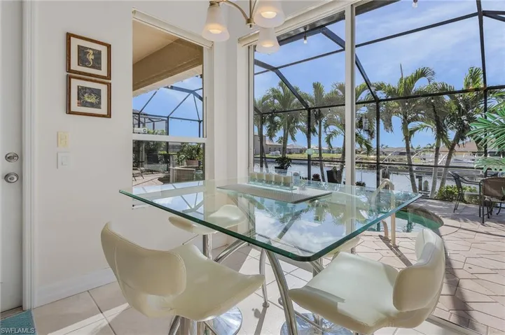 Sunroom / solarium featuring a water view